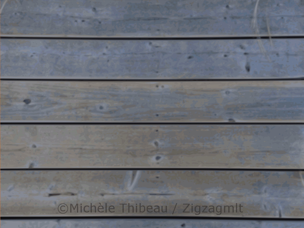 The bluish planks of the wharf, the walkway at Paspebiac in the region of Gaspé, captured in the light of evening.