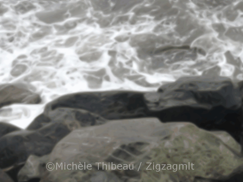 A glimpse of the rocks and the water on the old walkway at PercÃ©. You can hear, smell and feel the water spray.